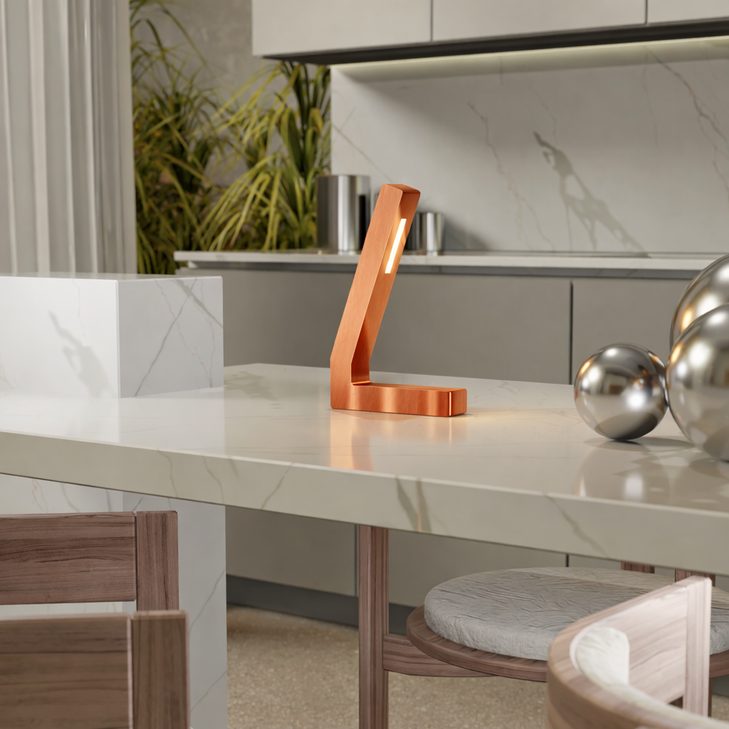 Handcrafted copper finish oak L-shaped LED lamp by WOOM on a white marble countertop with decorative chrome balls.