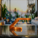 Copper finish Z-shaped lamp by WOOM on a reflective black marble table.