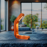 Curved wooden LED lamp with copper finish by WOOM, placed on a dark textured table in a modern room.