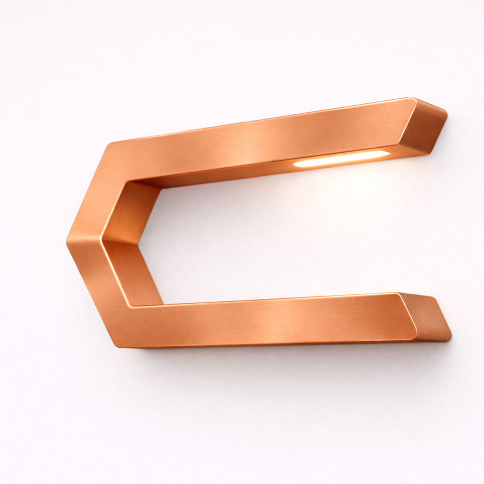 Copper finish C-shaped LED lamp by WOOM, with a brushed metal texture and glow from the top edge, mounted on a white wall.