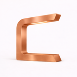 Copper finish C-shaped lamp by WOOM with a brushed metallic texture and warm internal light.
