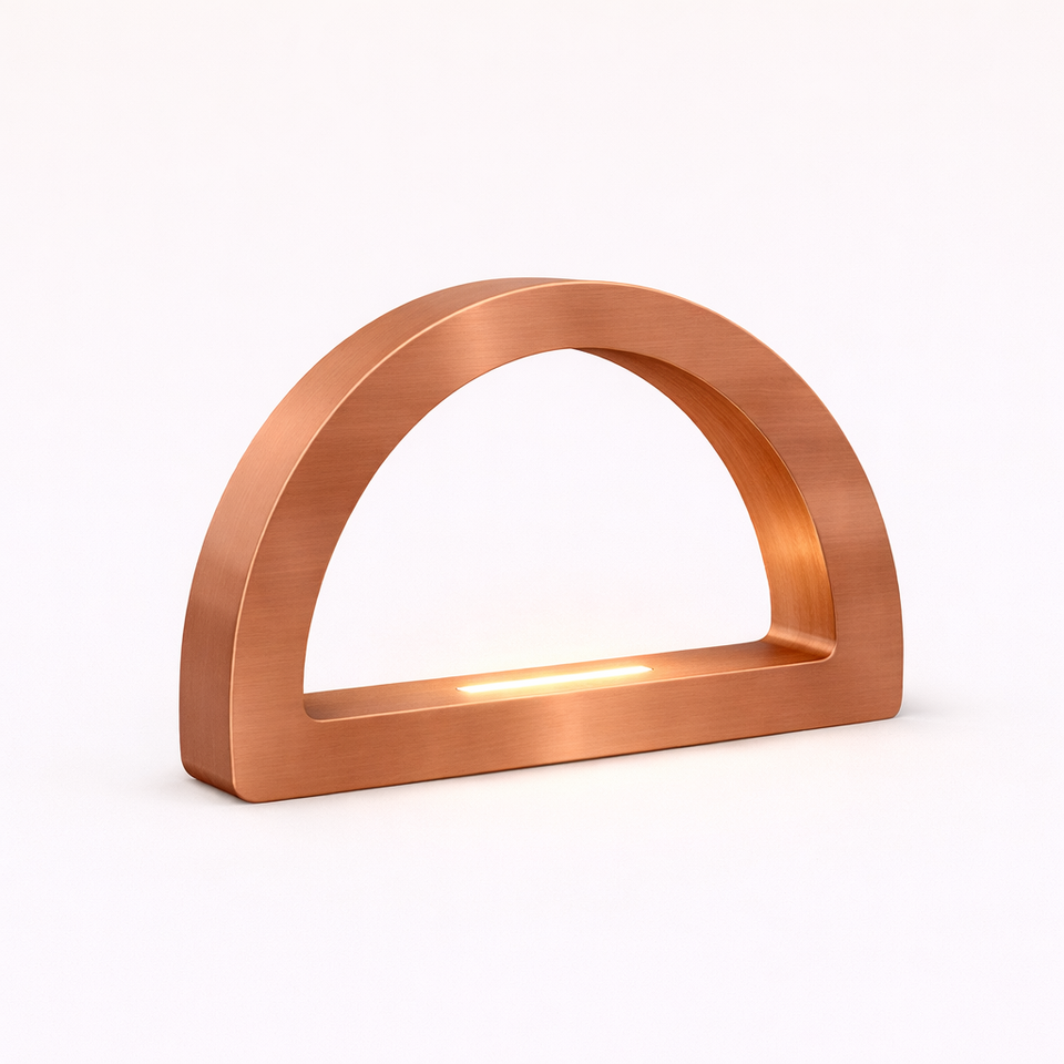 Brushed copper finish arc-curved desk lamp by WOOM, with an integrated strip light.