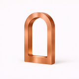 Copper finish U-shaped desk lamp by WOOM with a brushed texture on a white background.