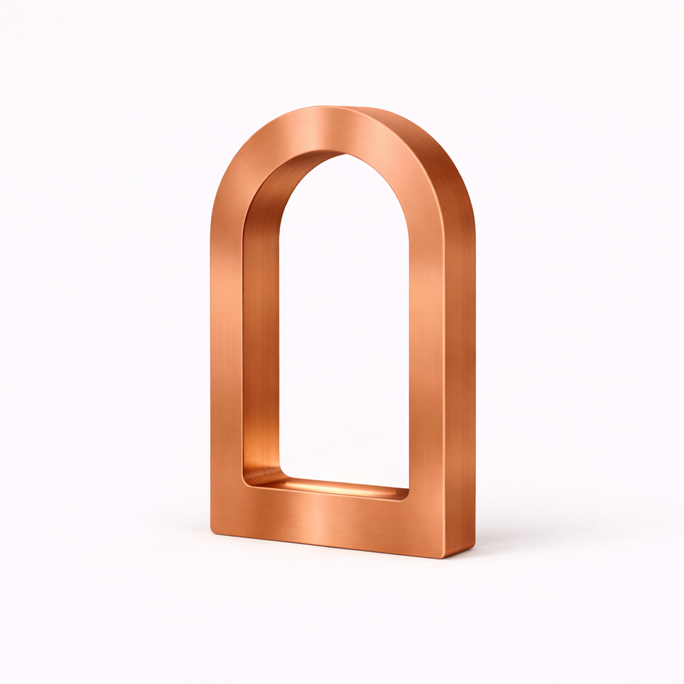 Copper finish U-shaped desk lamp by WOOM with a brushed texture on a white background.