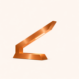 Copper finish angular table lamp by WOOM, with an integrated light strip, on a light background.