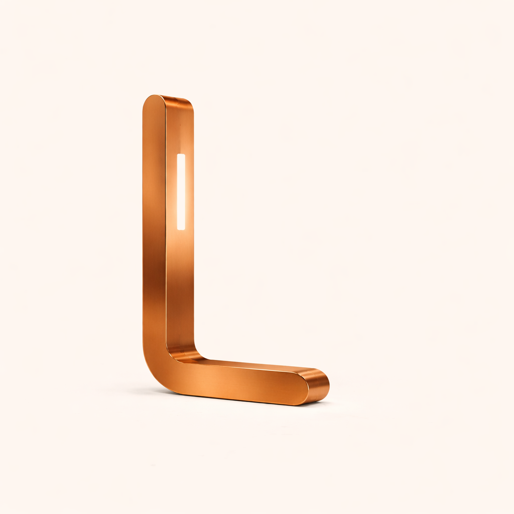 Copper-toned L-shaped LED lamp by WOOM, with a glowing vertical light strip.