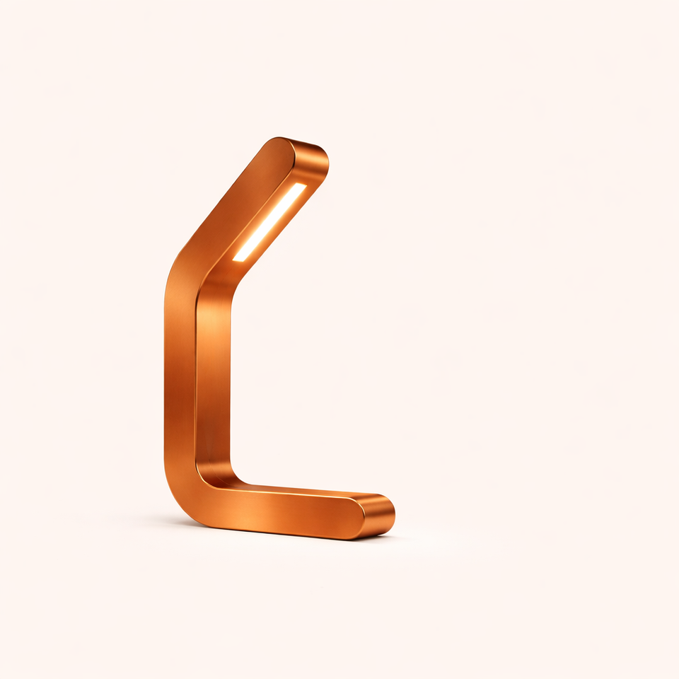 A sleek, copper-finish curved LED table lamp by WOOM, with a minimalist C-shaped design and glowing light strip.