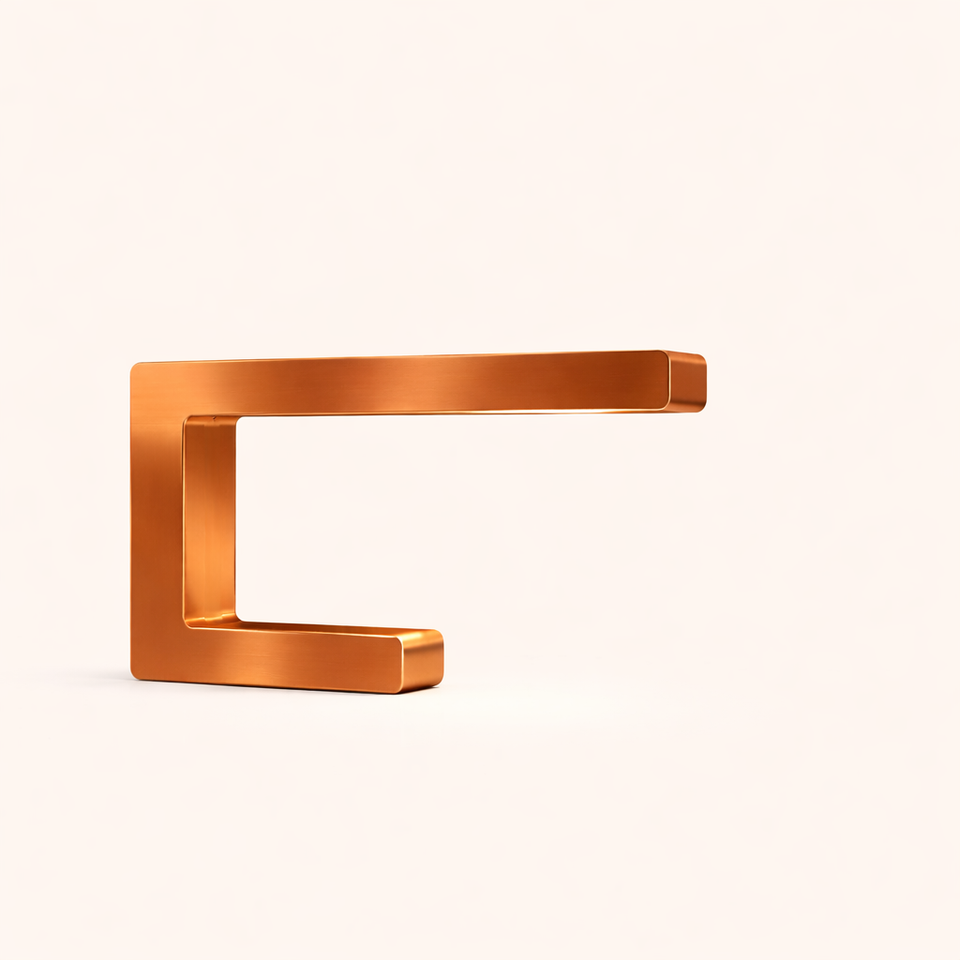 Copper-finish C-shaped lamp by WOOM with a brushed metallic texture and rounded edges.