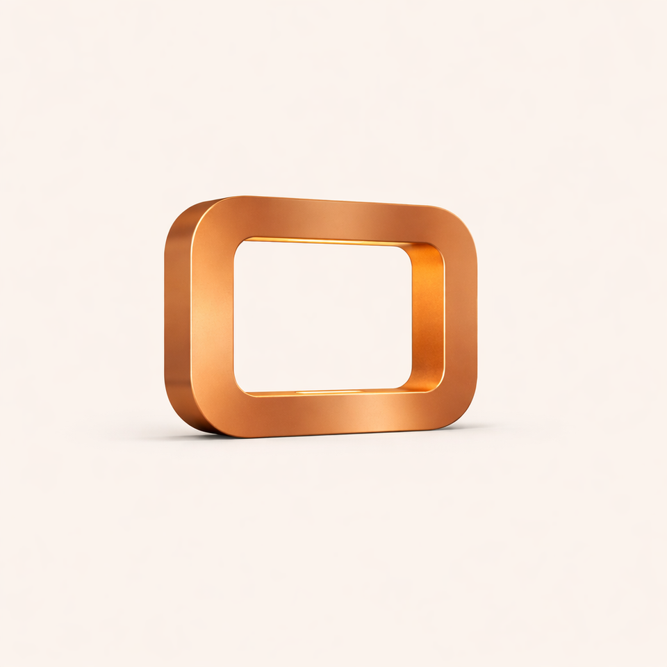 Copper-finish rectangular lamp by WOOM with rounded corners and a smooth, reflective surface, casting a subtle shadow.