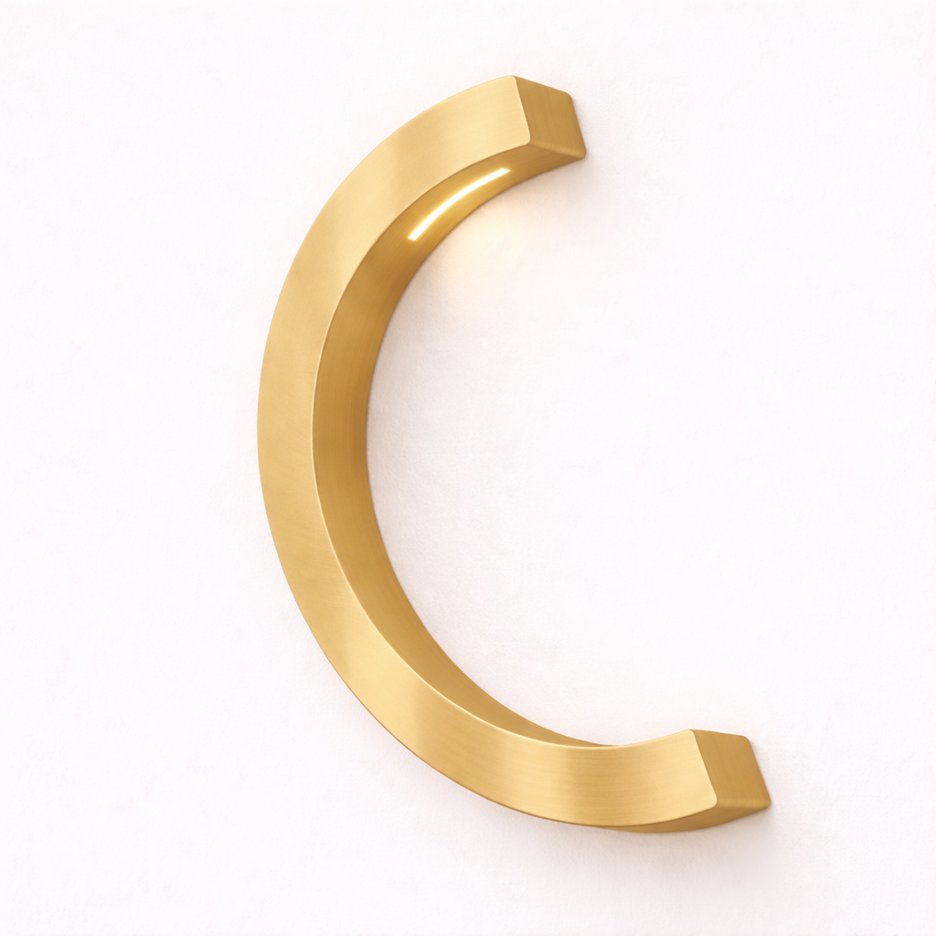 Gold finish C-curved wooden desk lamp by WOOM, featuring a light glowing from its inner curve.