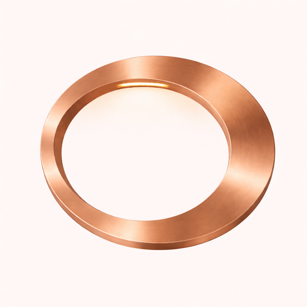 Oval lamp with a brushed copper finish by WOOM, featuring a warm light on the inner top edge.