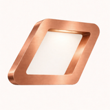 Copper finish square lamp by WOOM with brushed texture, framing a glowing white interior.
