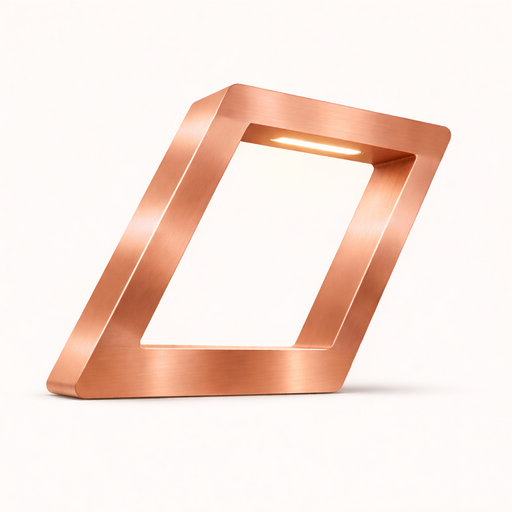 Copper finish table lamp by WOOM, featuring a brushed metal texture and a tilted square frame with an integrated LED light.