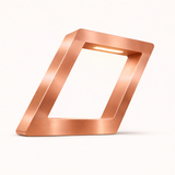 Copper finish table lamp by WOOM, featuring a brushed metal texture and a tilted square frame with an integrated LED light.
